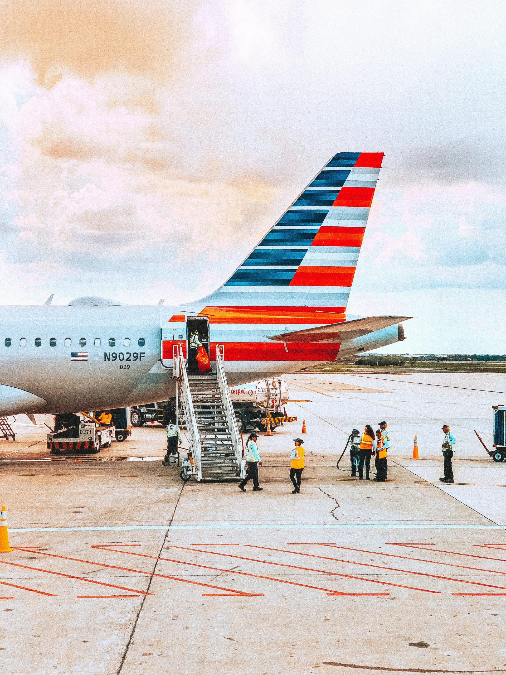 A colorful airliner being prepared for boarding on a sunny day at an airport.
